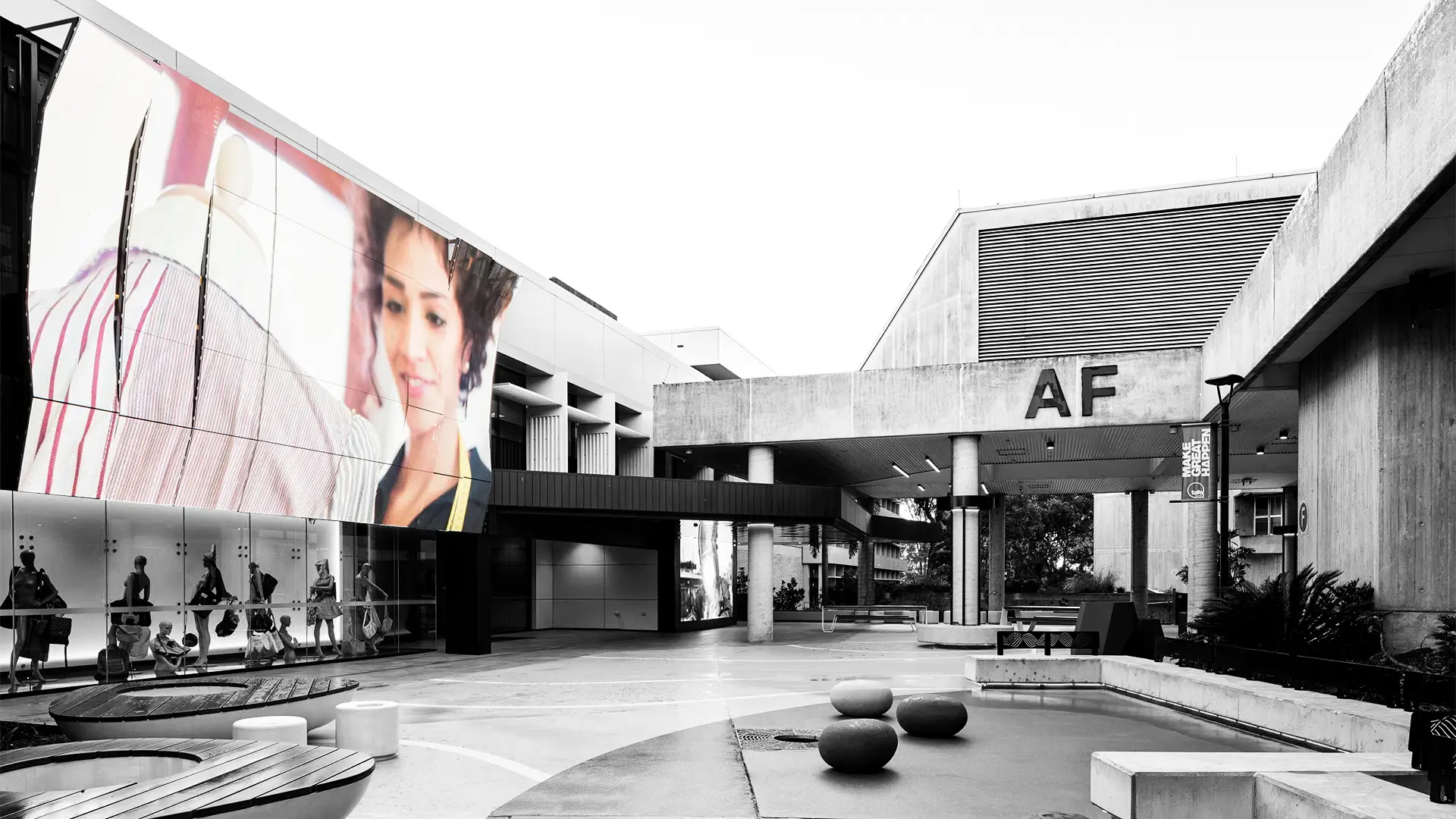 Transparent LED display screen installed at TAFE Mt Gravatt showcasing vibrant visuals in a clear-glass facade