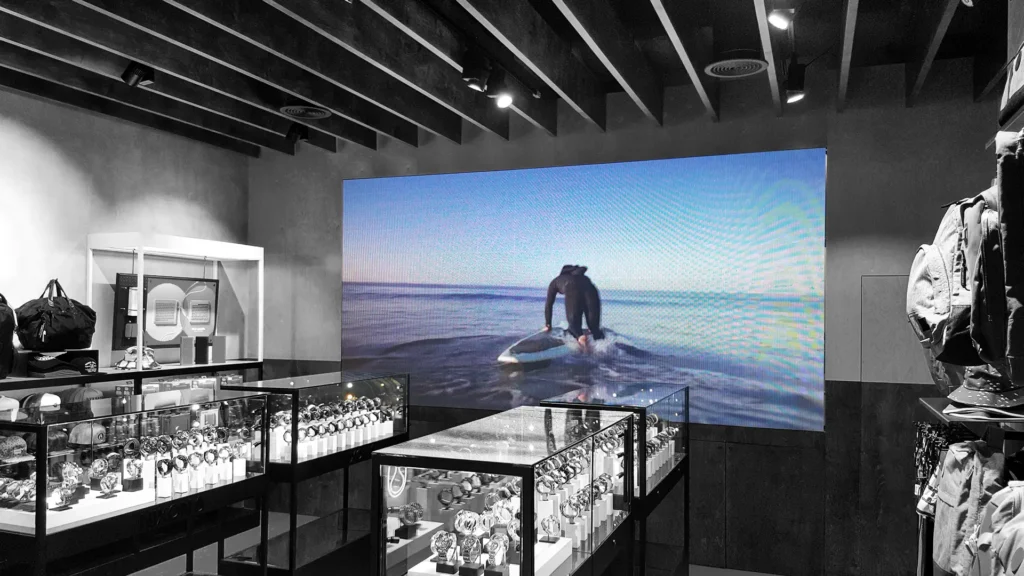 Retail LED display screen promoting Nixon watches in storefront